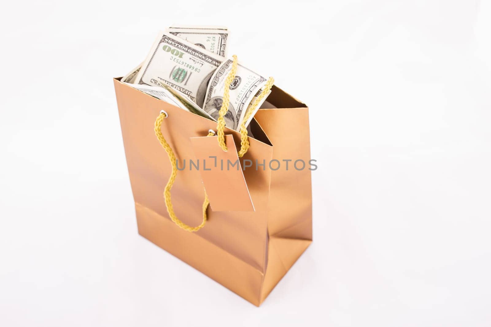 A gold gift bag with dollars isolated.