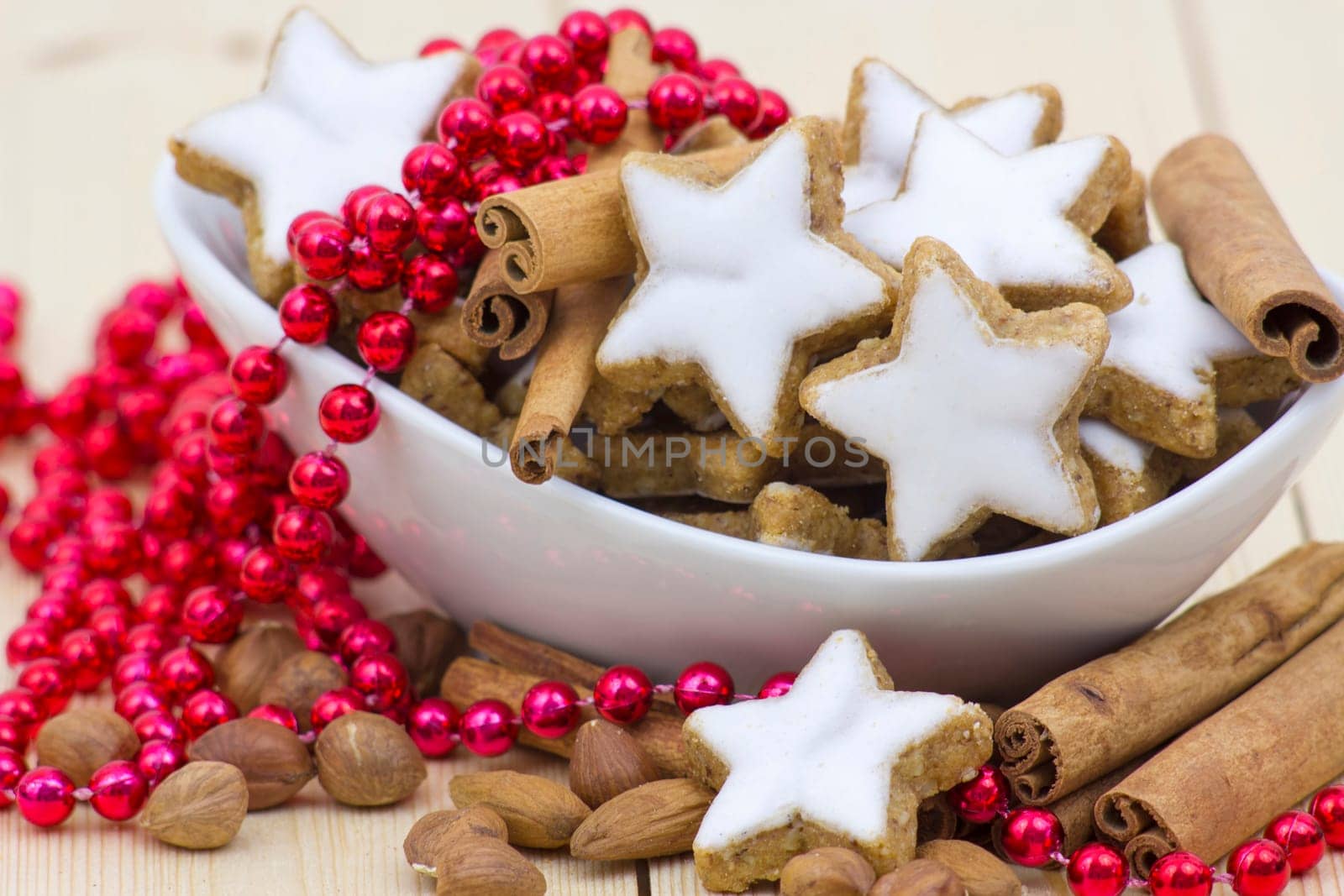 typical christmas cinnamon star cookies, nuts and cinnamon sticks
