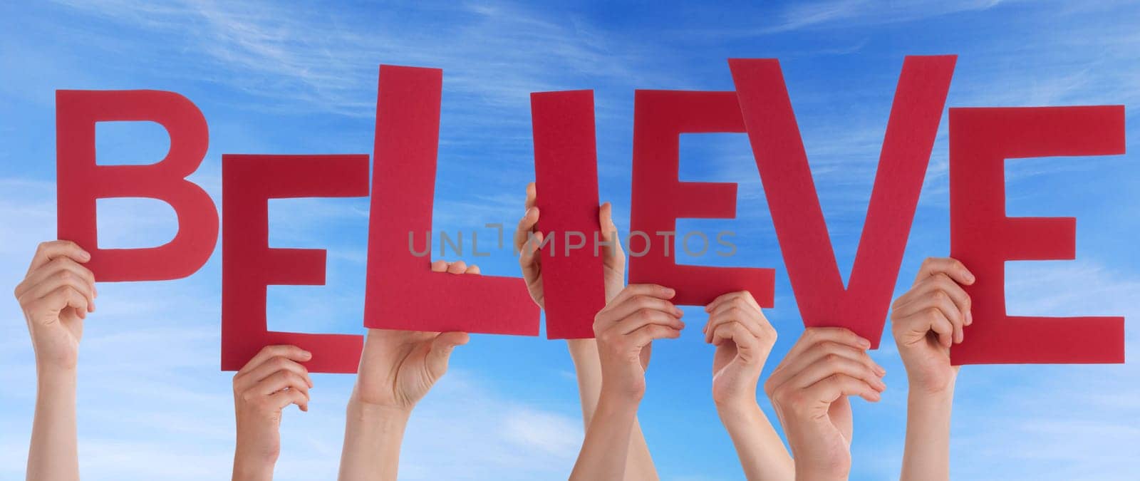 hands holding four pieces of a puzzle with copy space, gray background