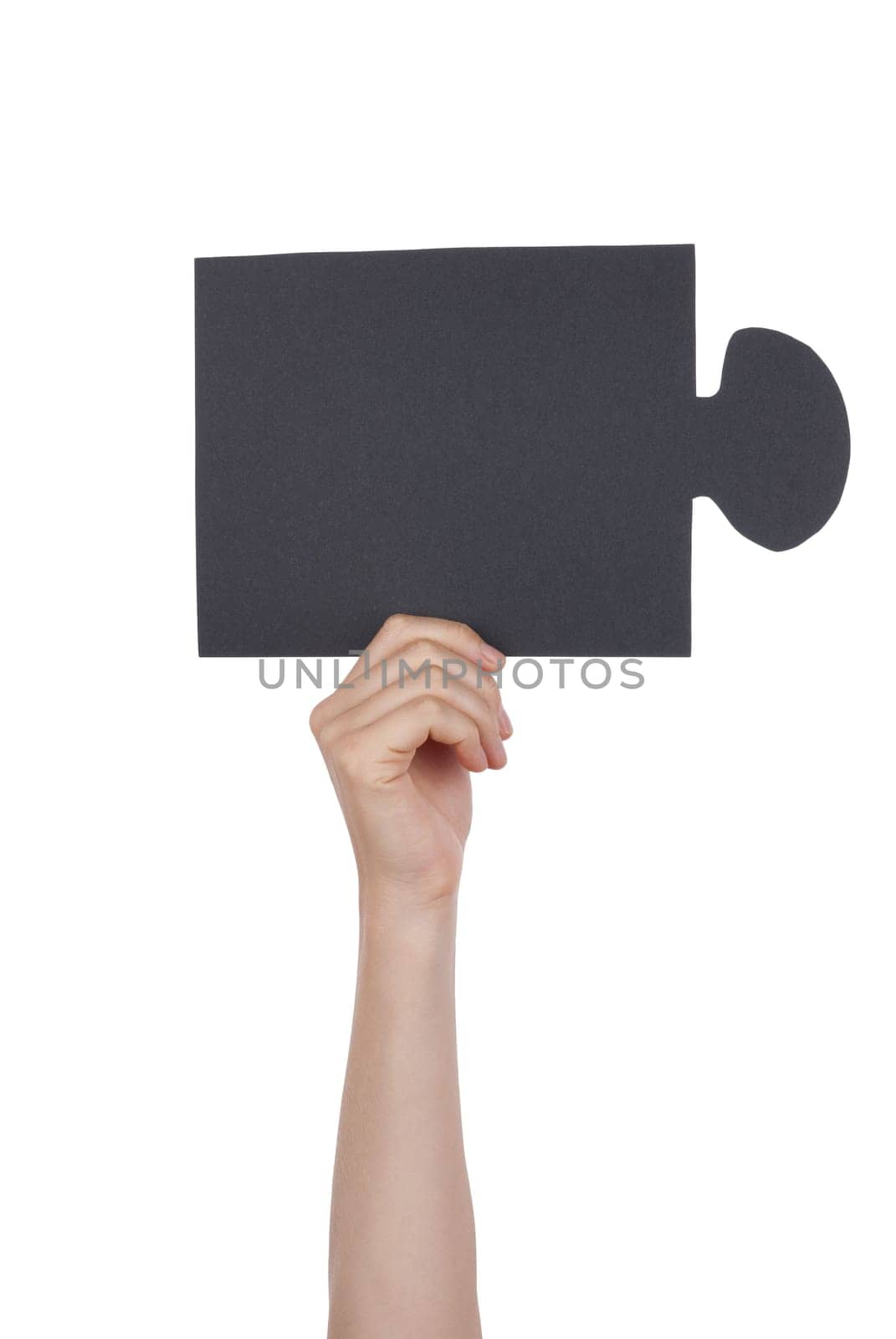 Hand Holding a Black Piece of a Puzzle, Isolated