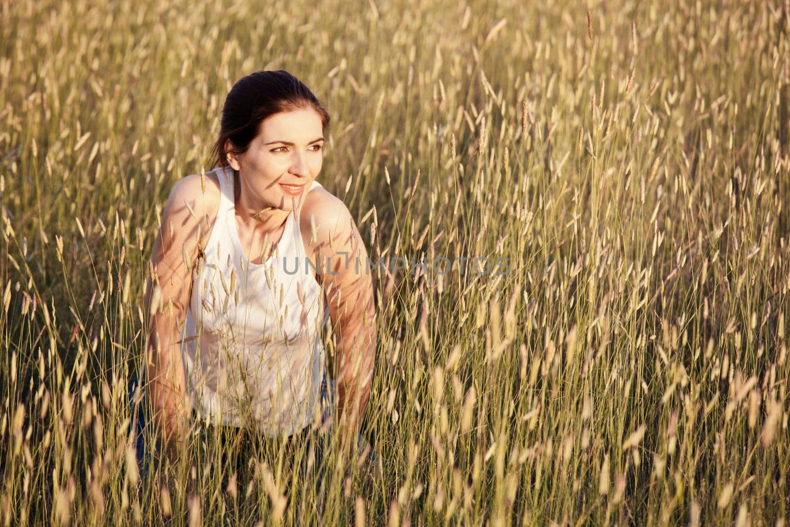 Outdoor portrait of a woman in a meadow on a summer day