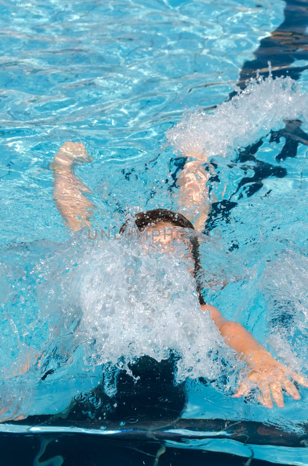 girl diving into swimming pool