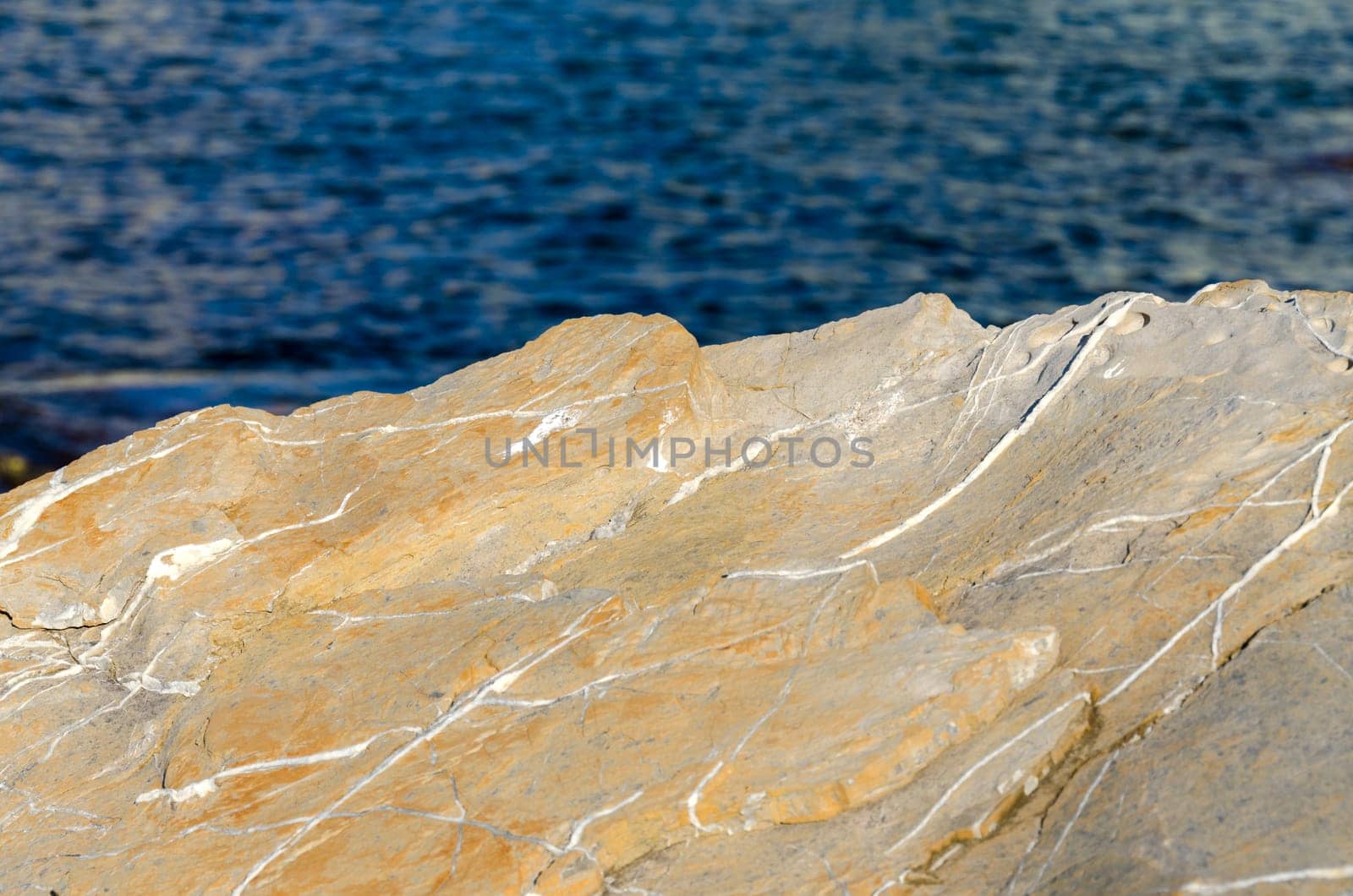 yellow rock on the blue sea in Genoa