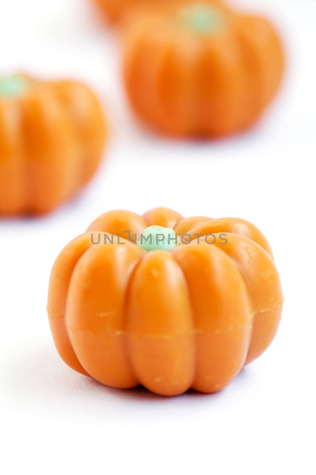 Group of halloween candy in shape of pumpkins on white background. Also useful as autumn concept.