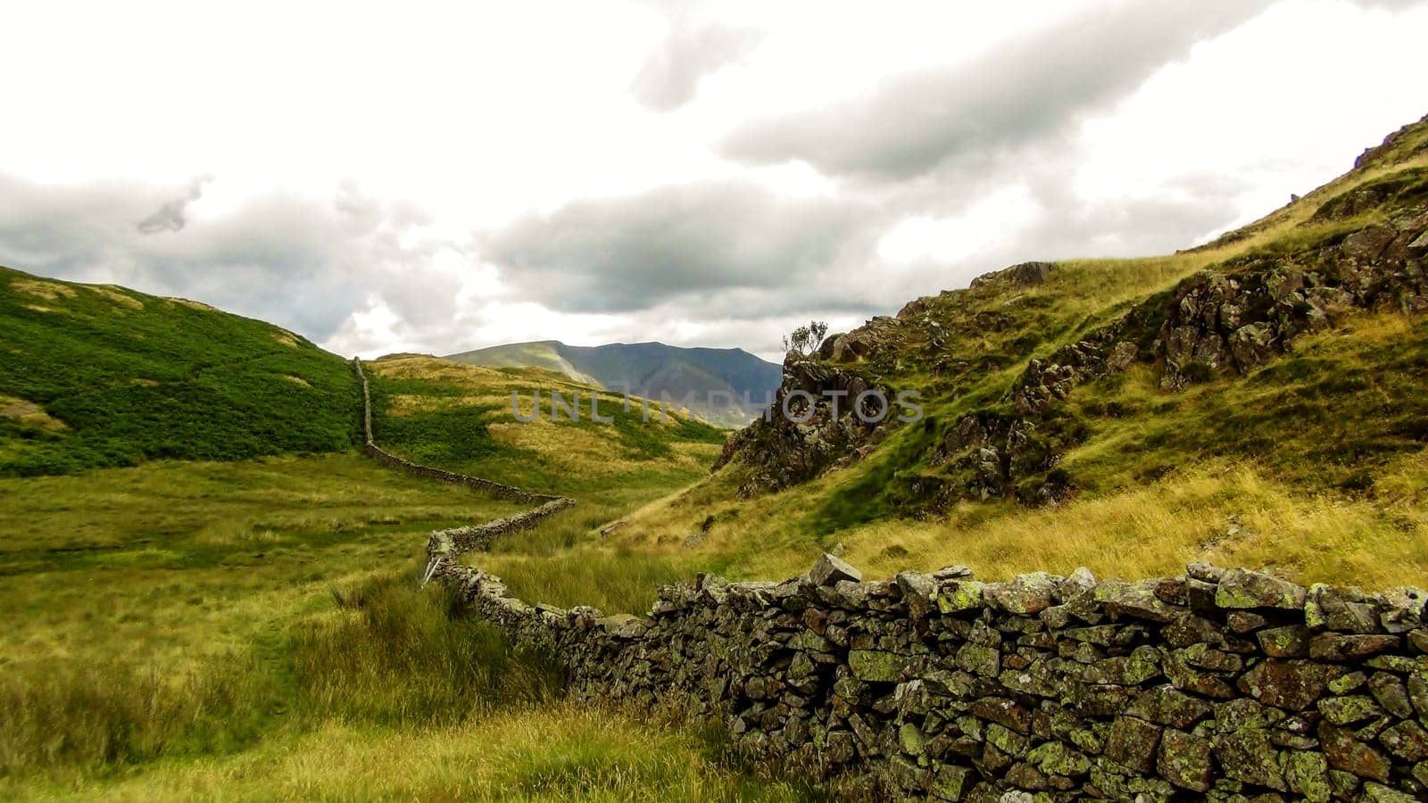 Old stone wall cutting through the hills
