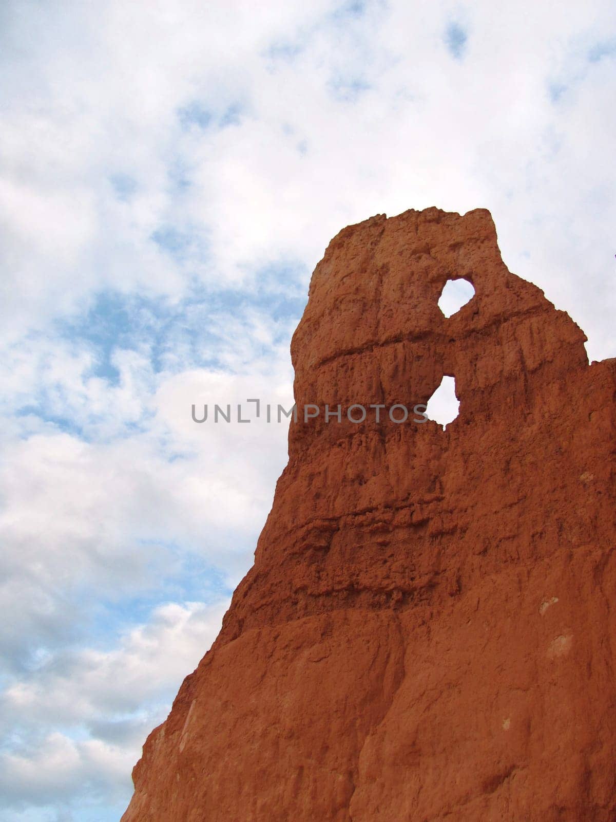 Red rock monument with arches over blue sky in the desert