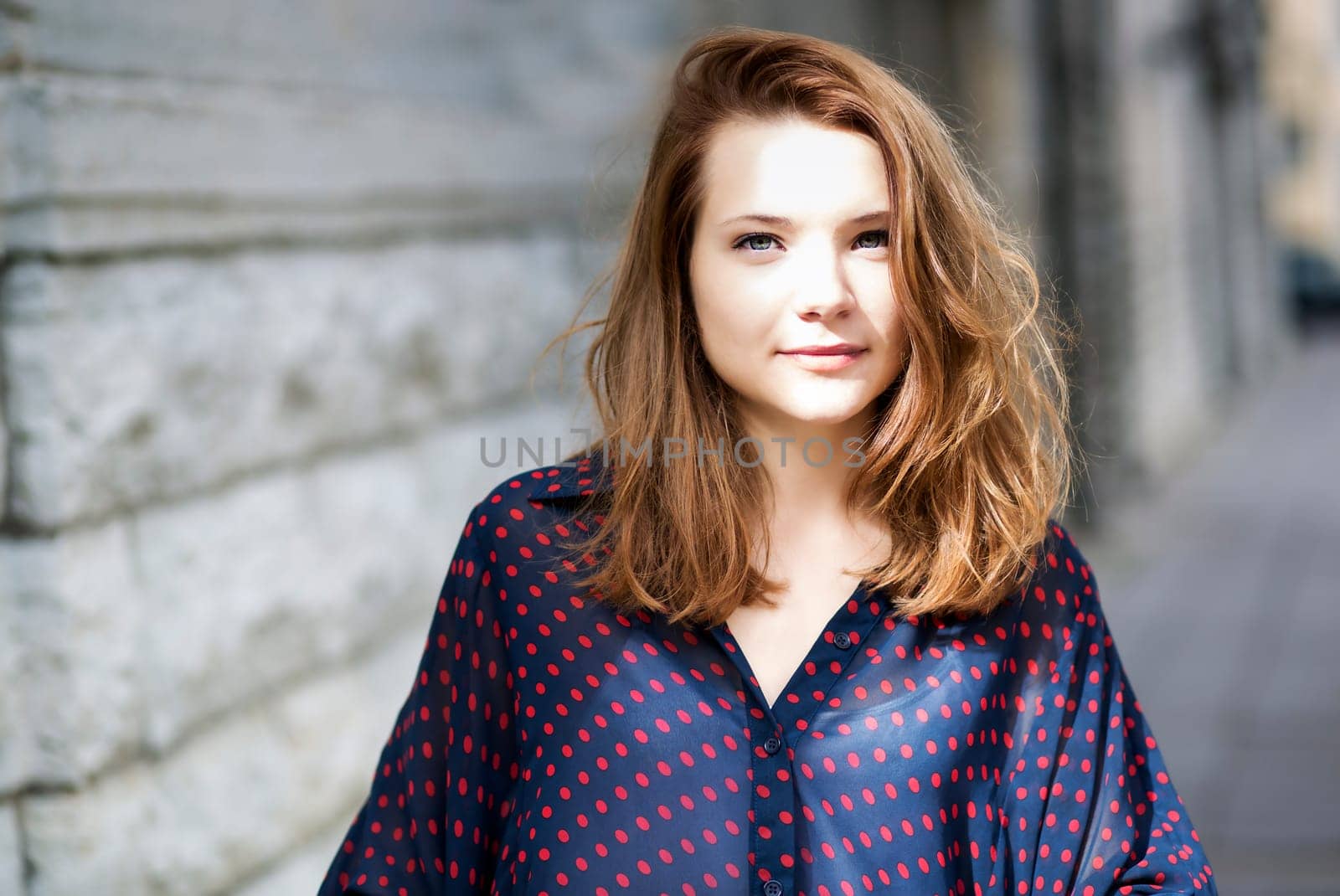 Zoomed young woman face with soft eyes look