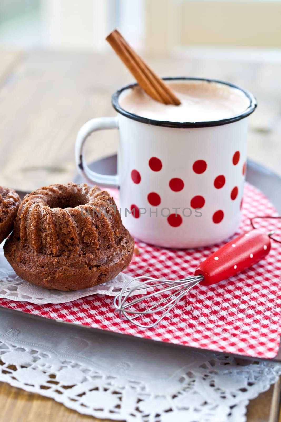 Hot chocolate in vintage cup with small chocolate cake