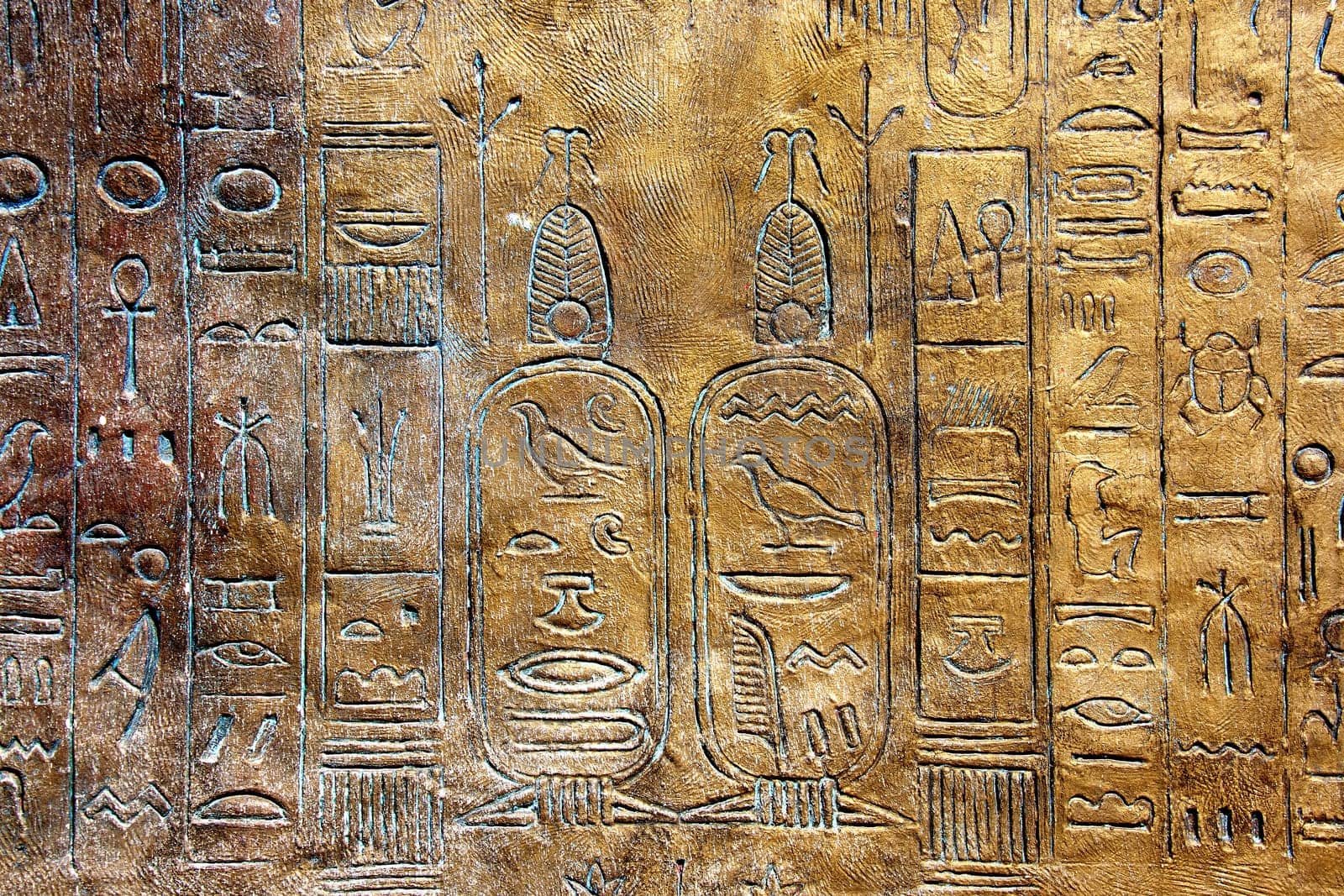Ancient hieroglyphs on stone wall.