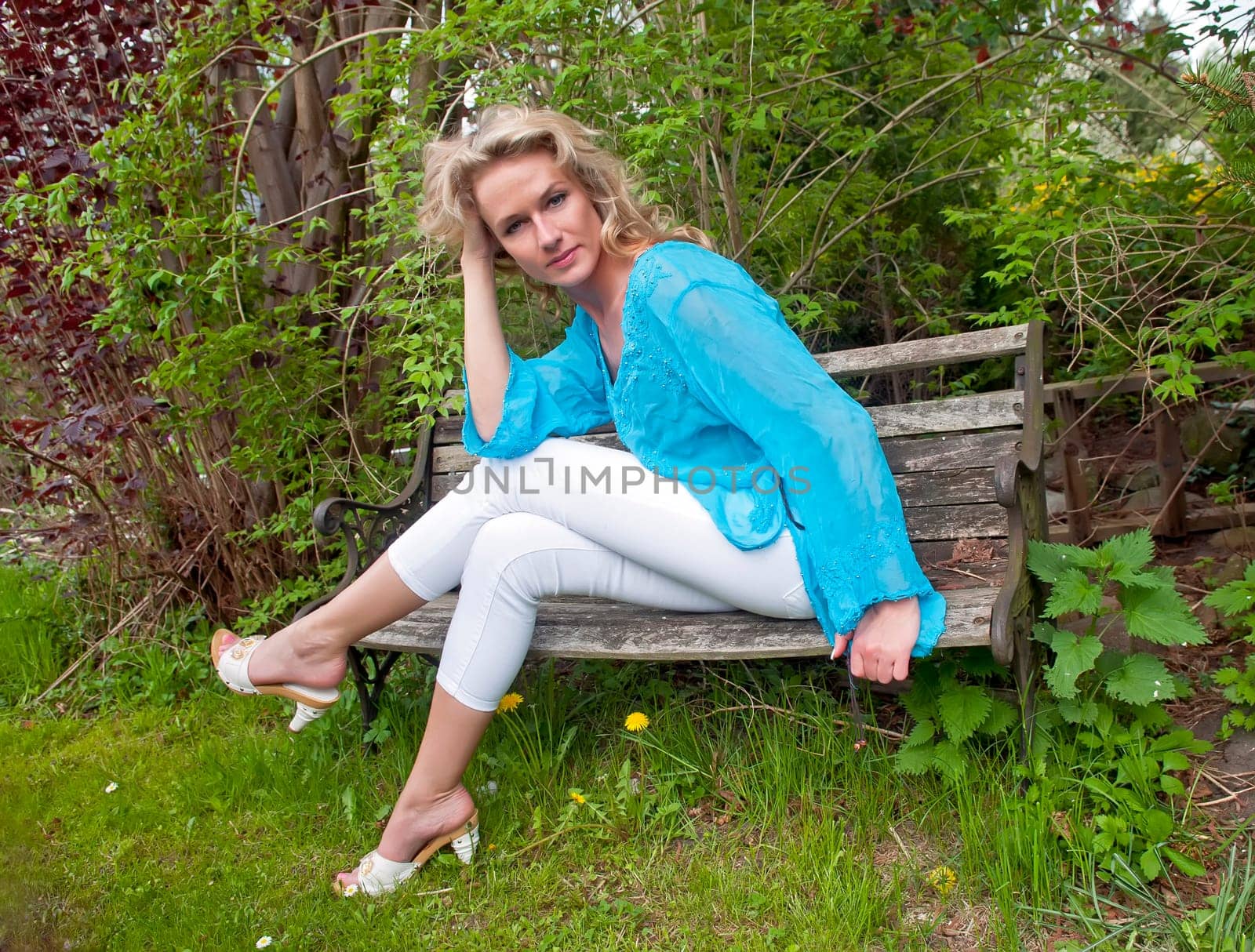 Young woman sitting on wooden bench