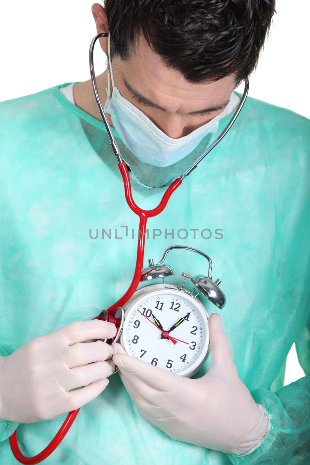 doctor auscultating  alarm clock