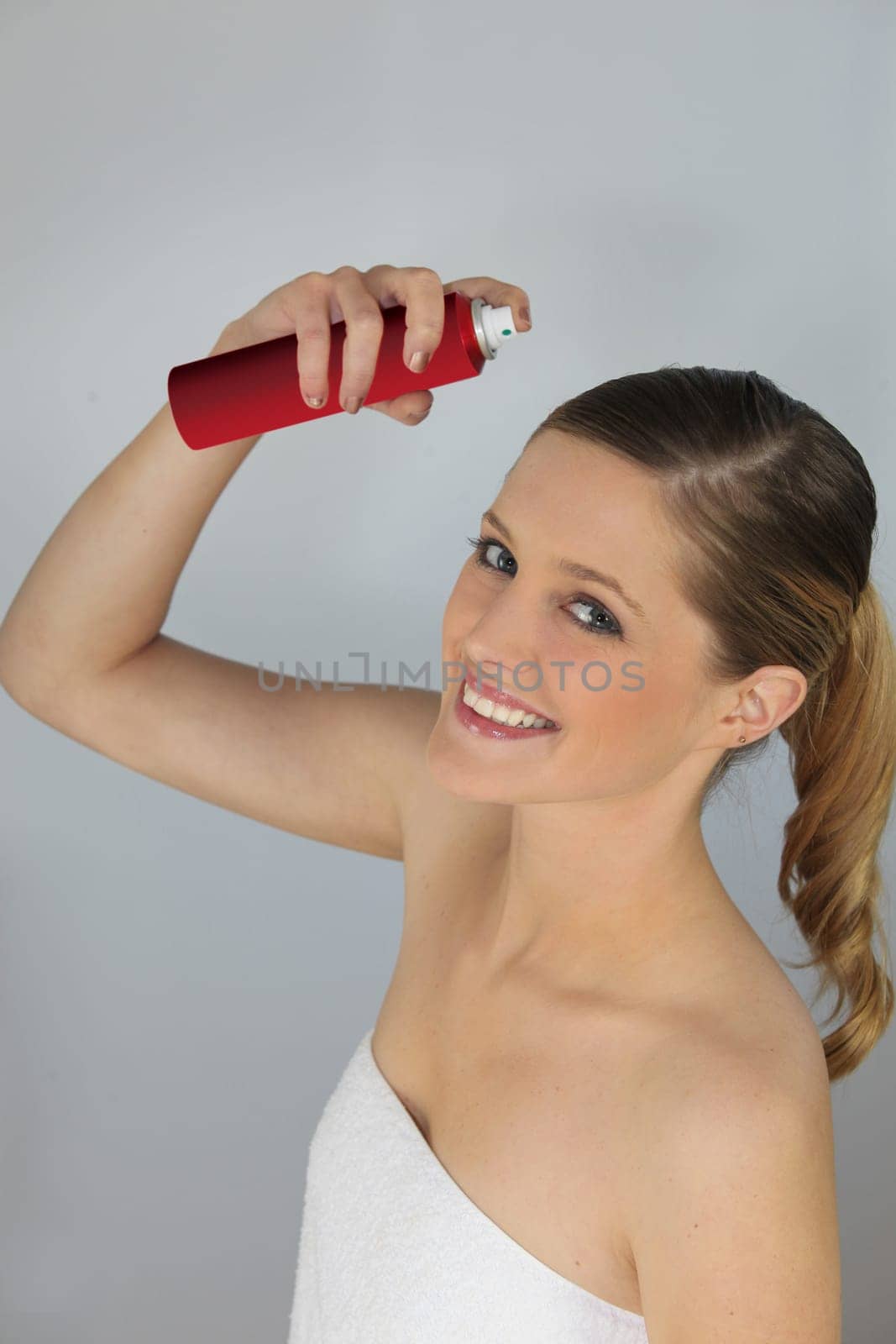 Woman using hair spray