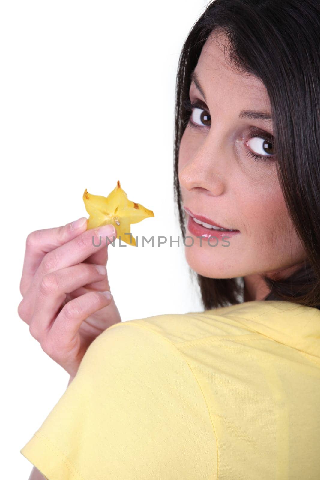 Woman with slice of star-shaped fruit