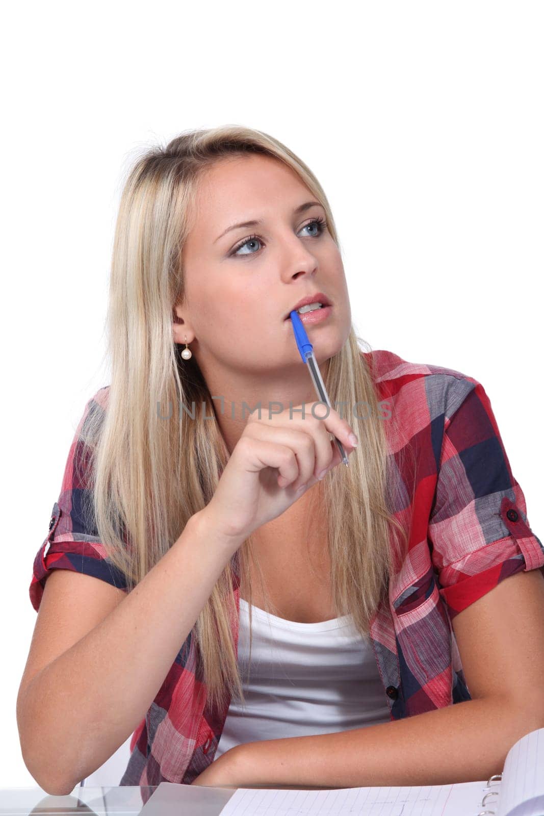 Student with a pen in her mouth