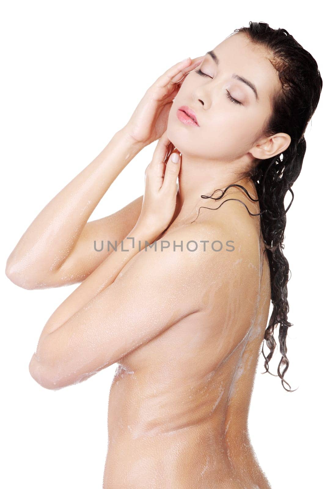 Young woman in shower washing her body