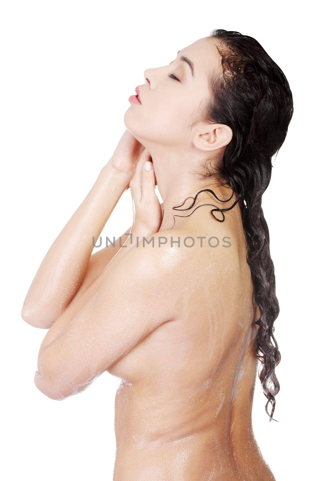 Young woman in shower washing her body
