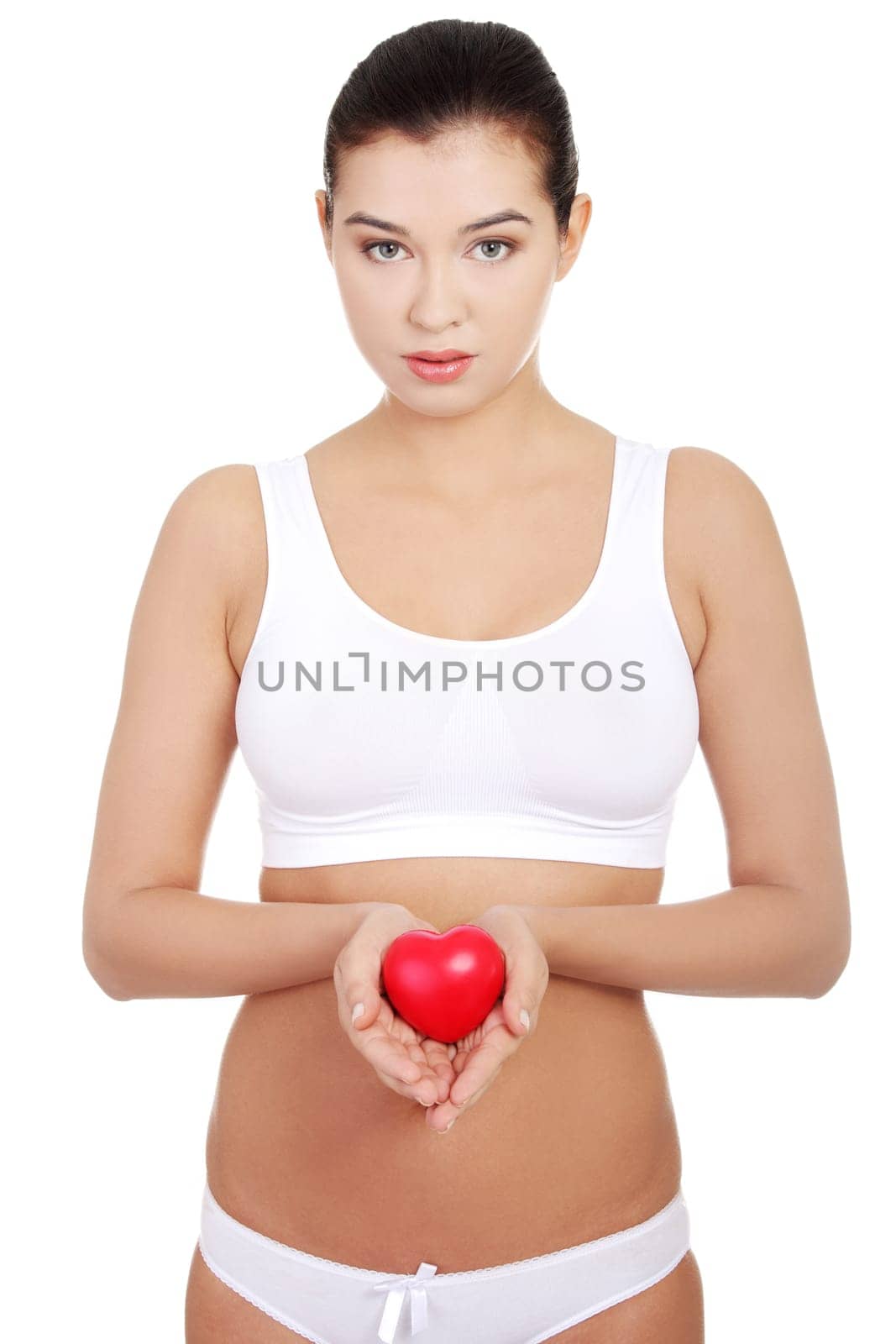 Happy Fit female in white sport underwear with red heart shaped toy
