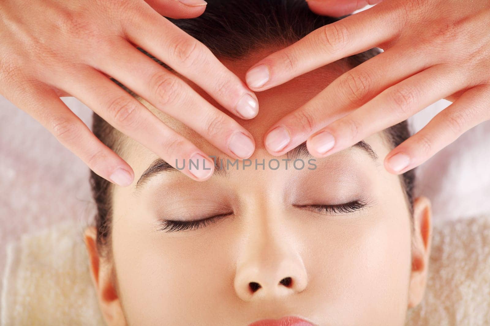 Beautiful young relaxed woman enjoy receiving massage at spa saloon