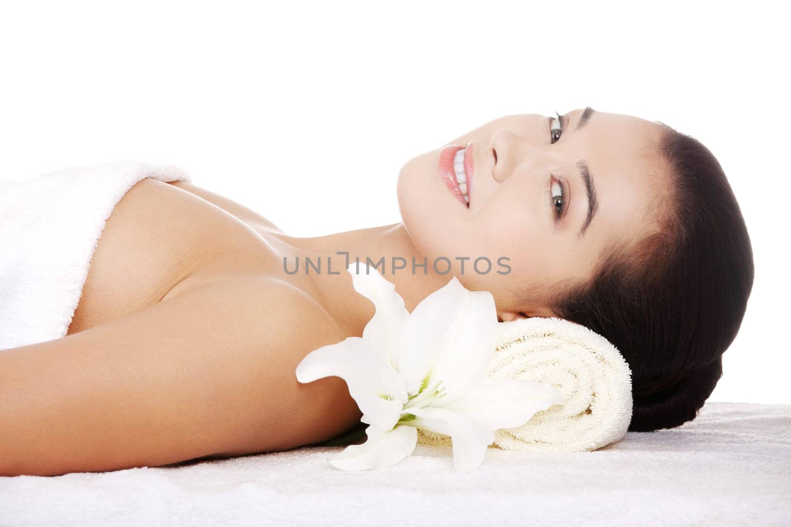 Beauty young woman relaxing in spa salon.