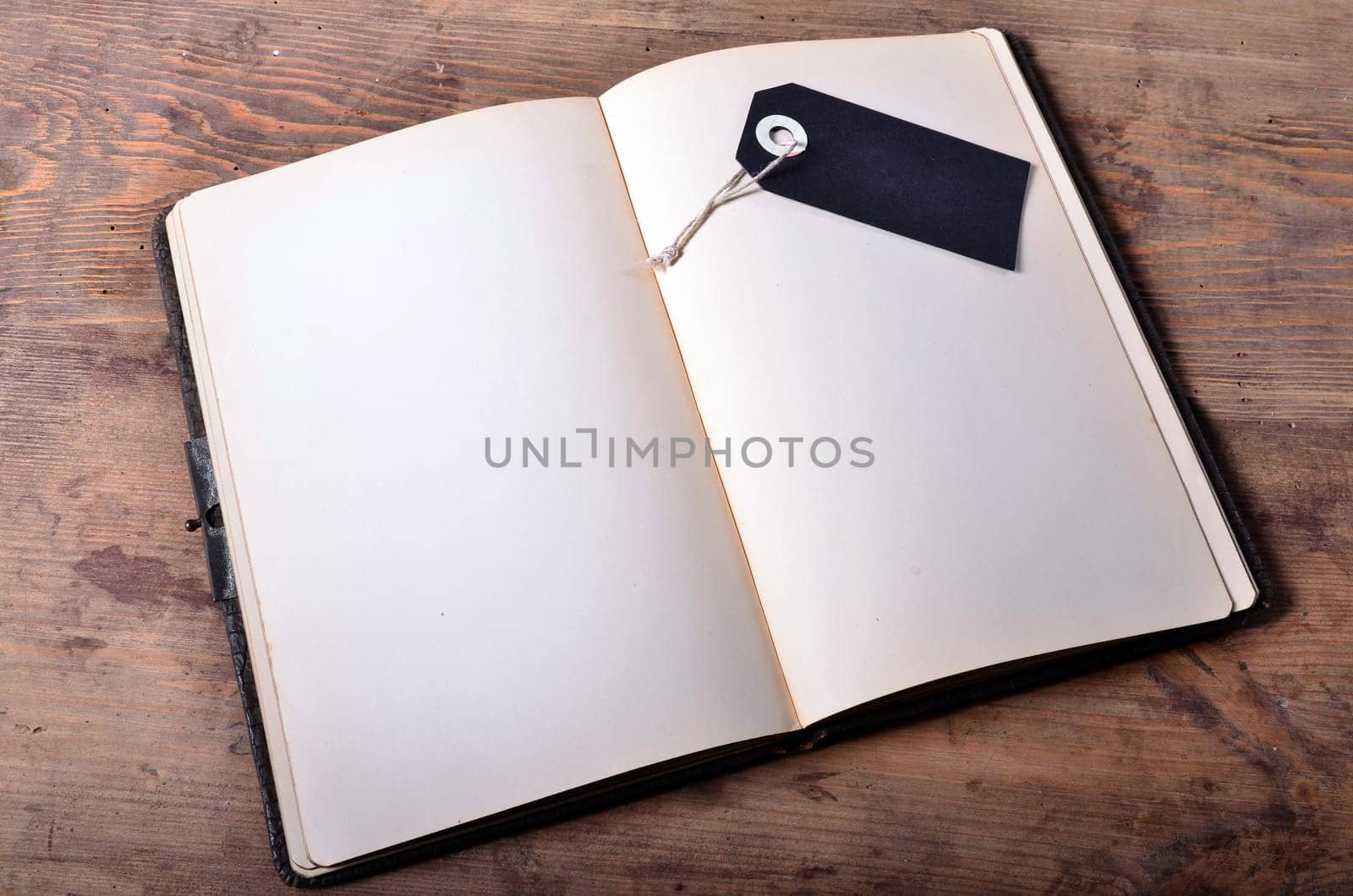 an old empty book on a wooden board background