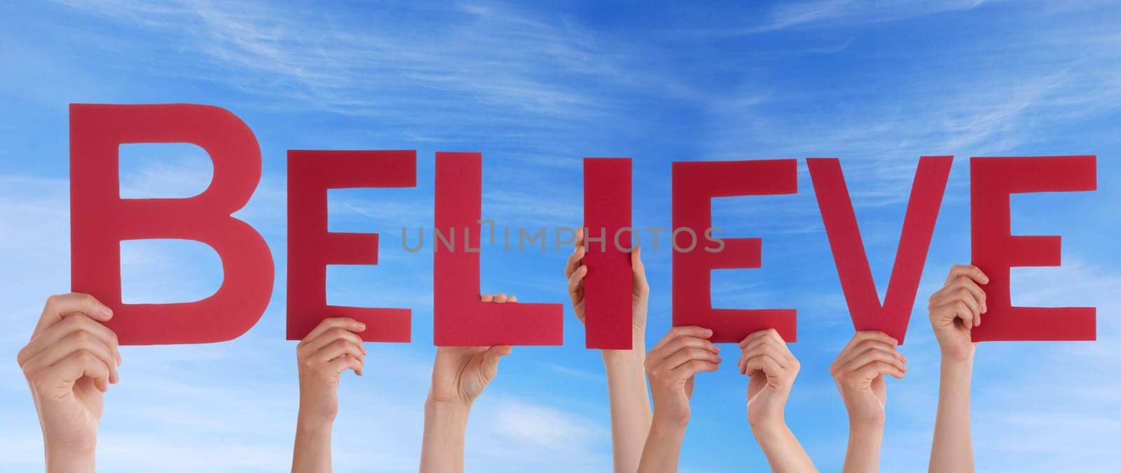 hands holding four pieces of a puzzle with copy space, gray background