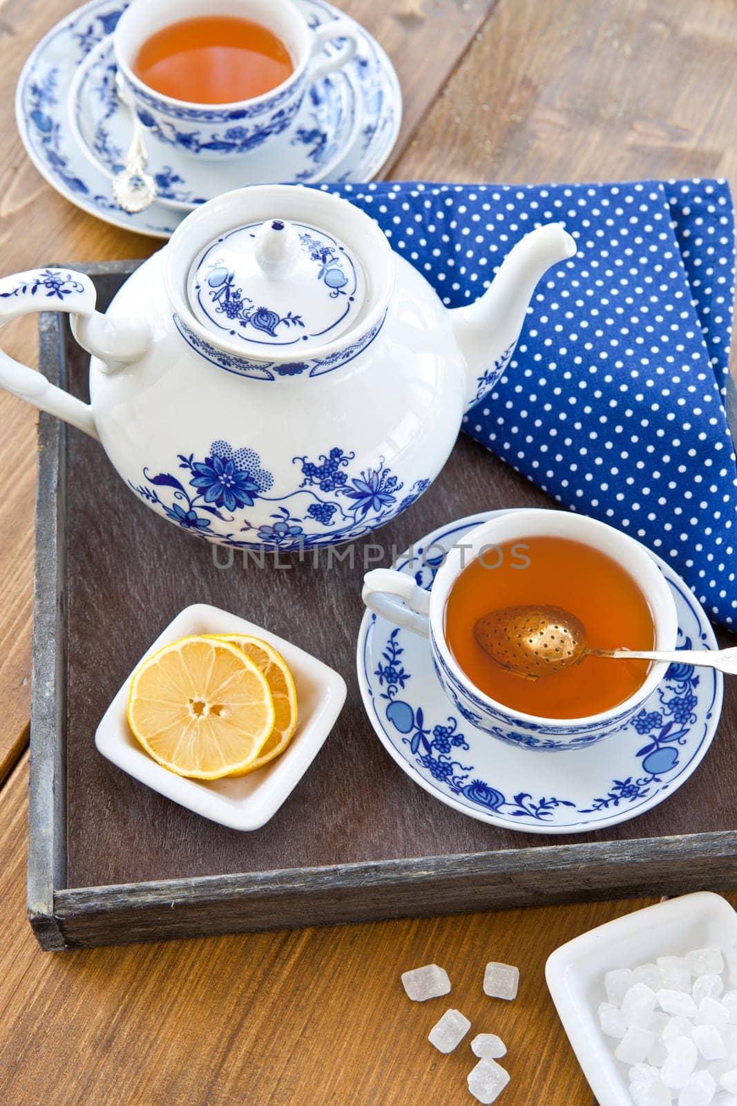 Tea in porcelain dishes with fresh lemon