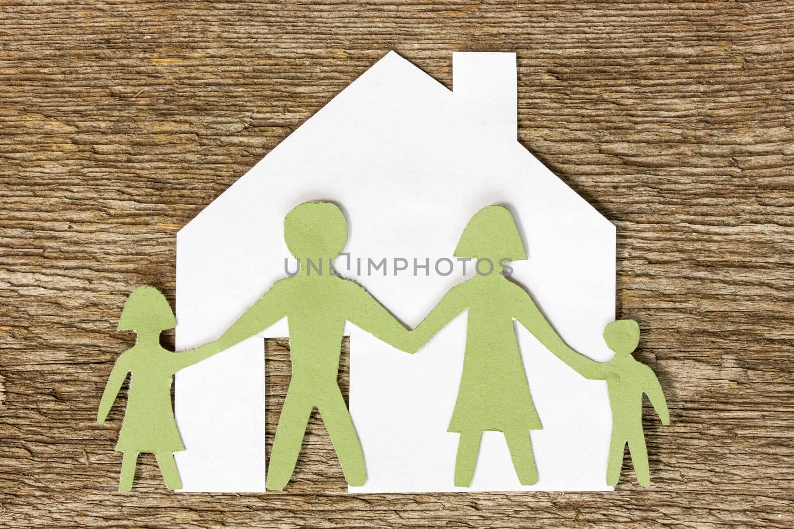 Paper cut of a house with family