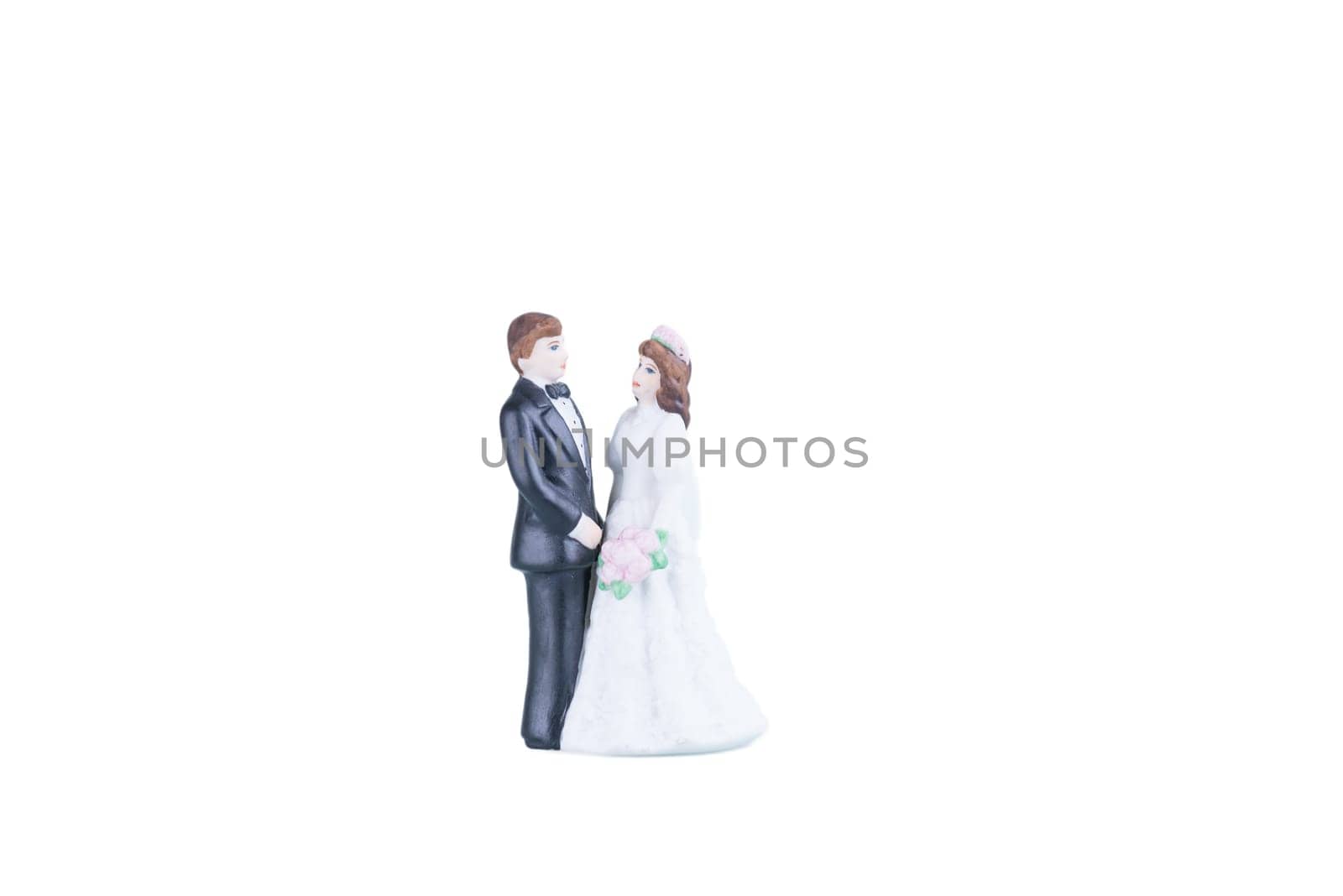 Procelain bride and groom over white background
