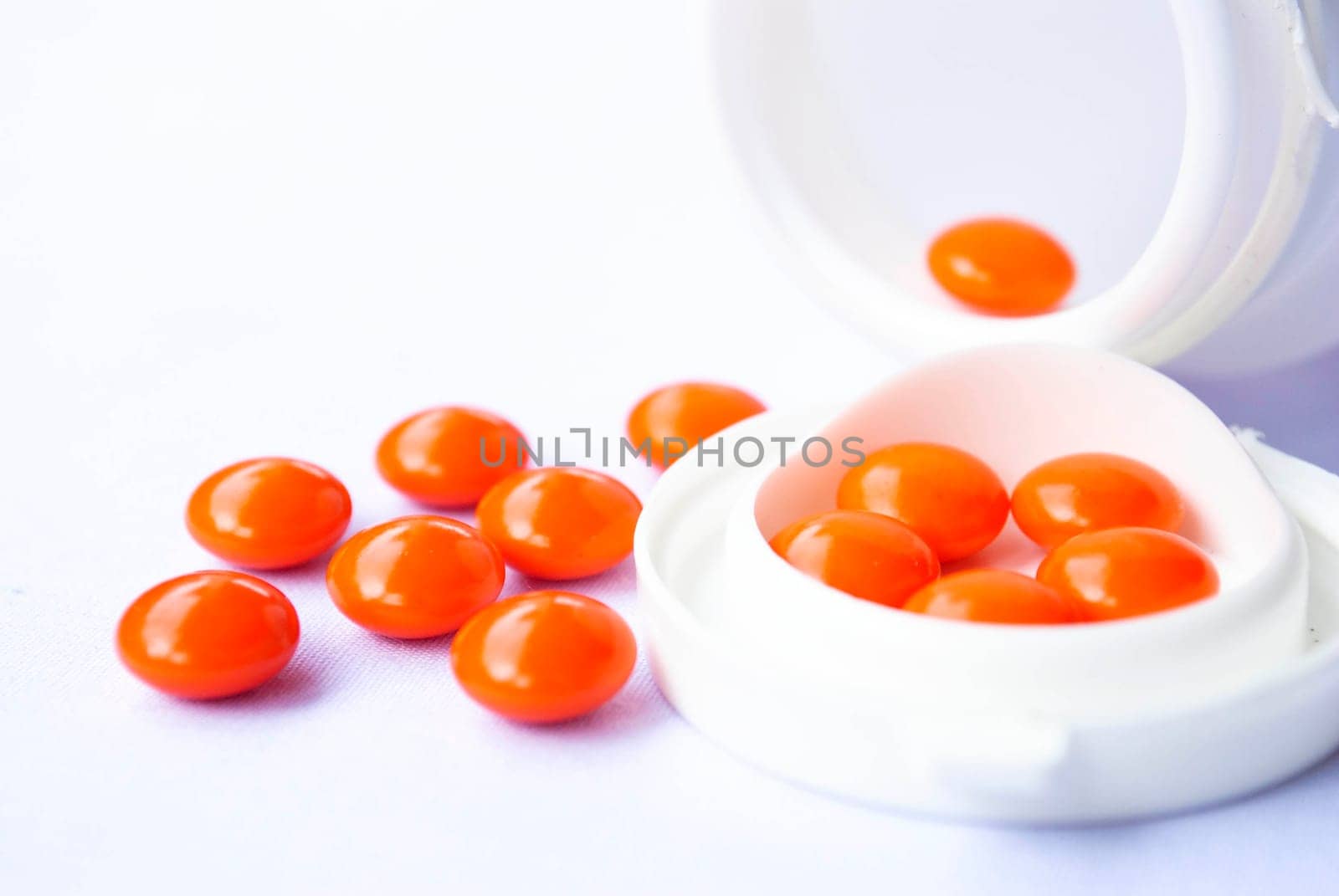 Pills pouring out of the white bottle