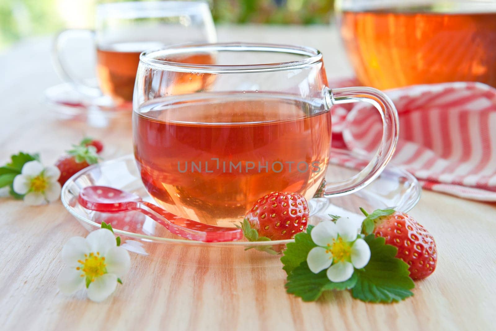 Breakfast tea with fresh strawberries in glass cups