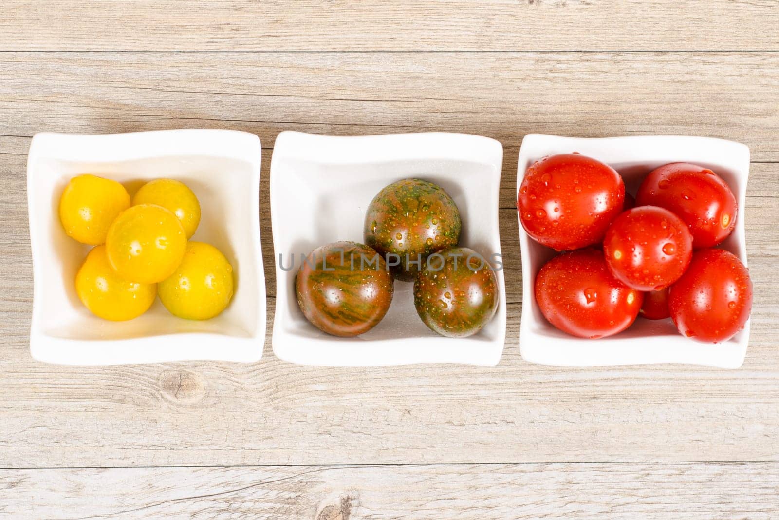 Various cocktail tomatoes in yellow,green and red in one bowl
