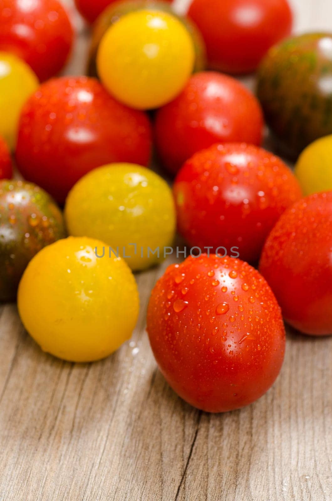 Close-up of different tomatoes in red,yellow and green in portrait format