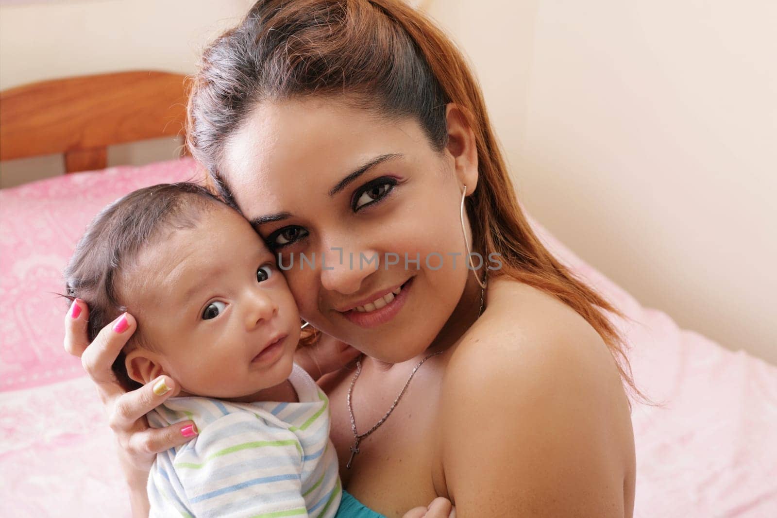 Portrait of a beautiful hispanic happy mother with smiling baby