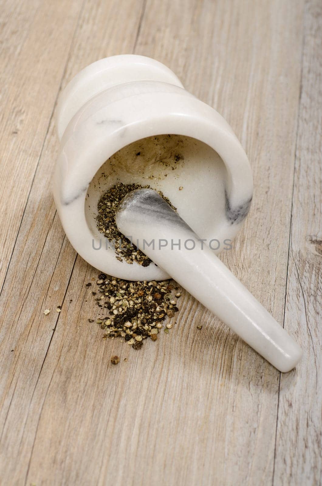 Black pepper crushed in mortar with pestle