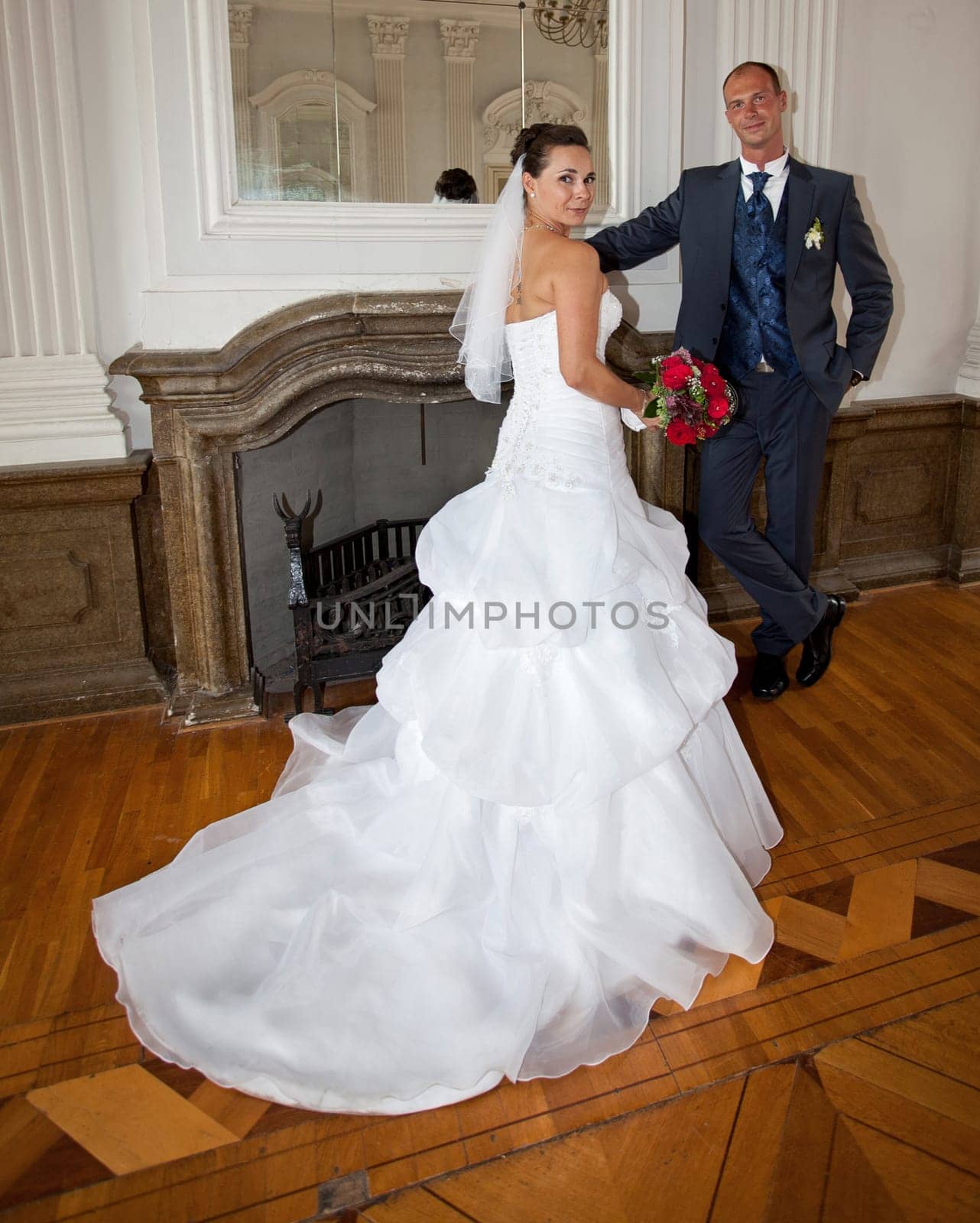 Bridal couple by the fireplace