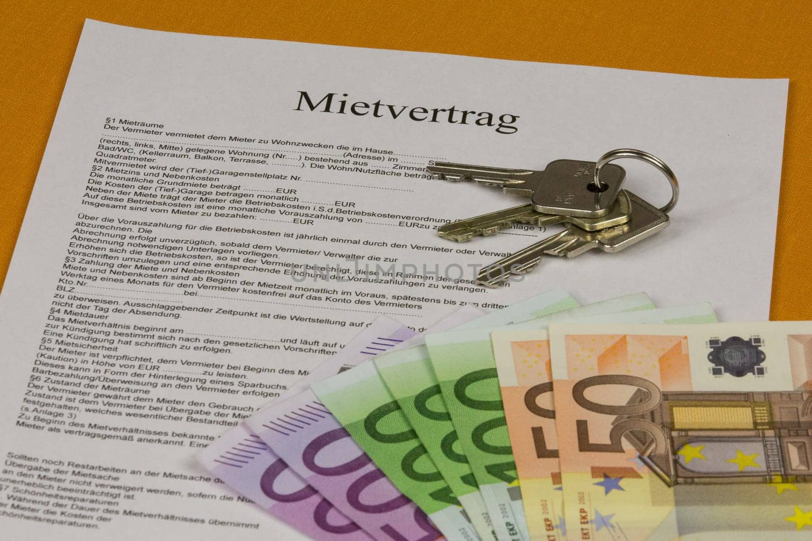 Rental agreement with house keys and banknotes