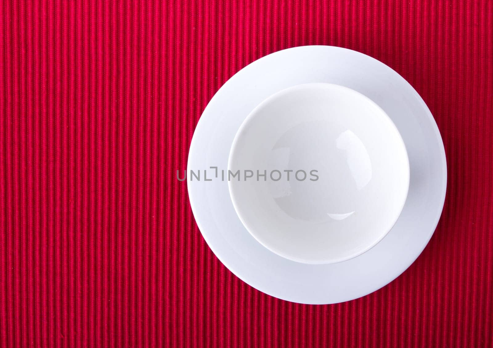 Empty bowl isolated on red background