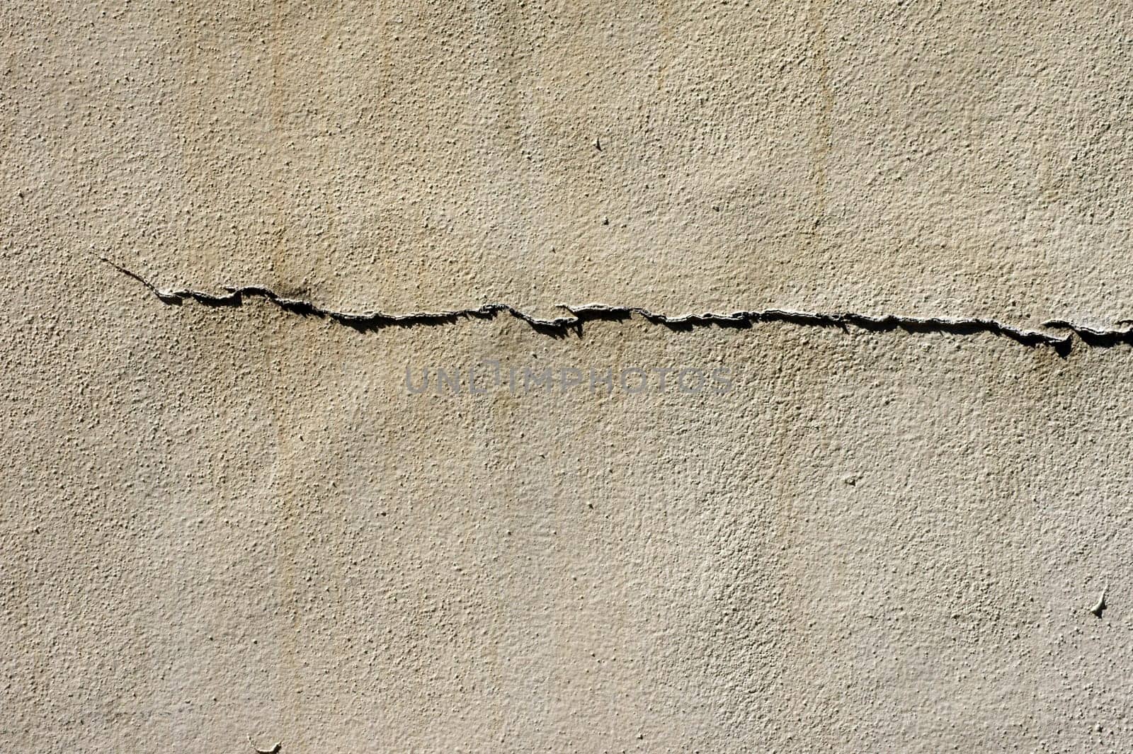 The close-up of a façade with a crack,usable as a background.