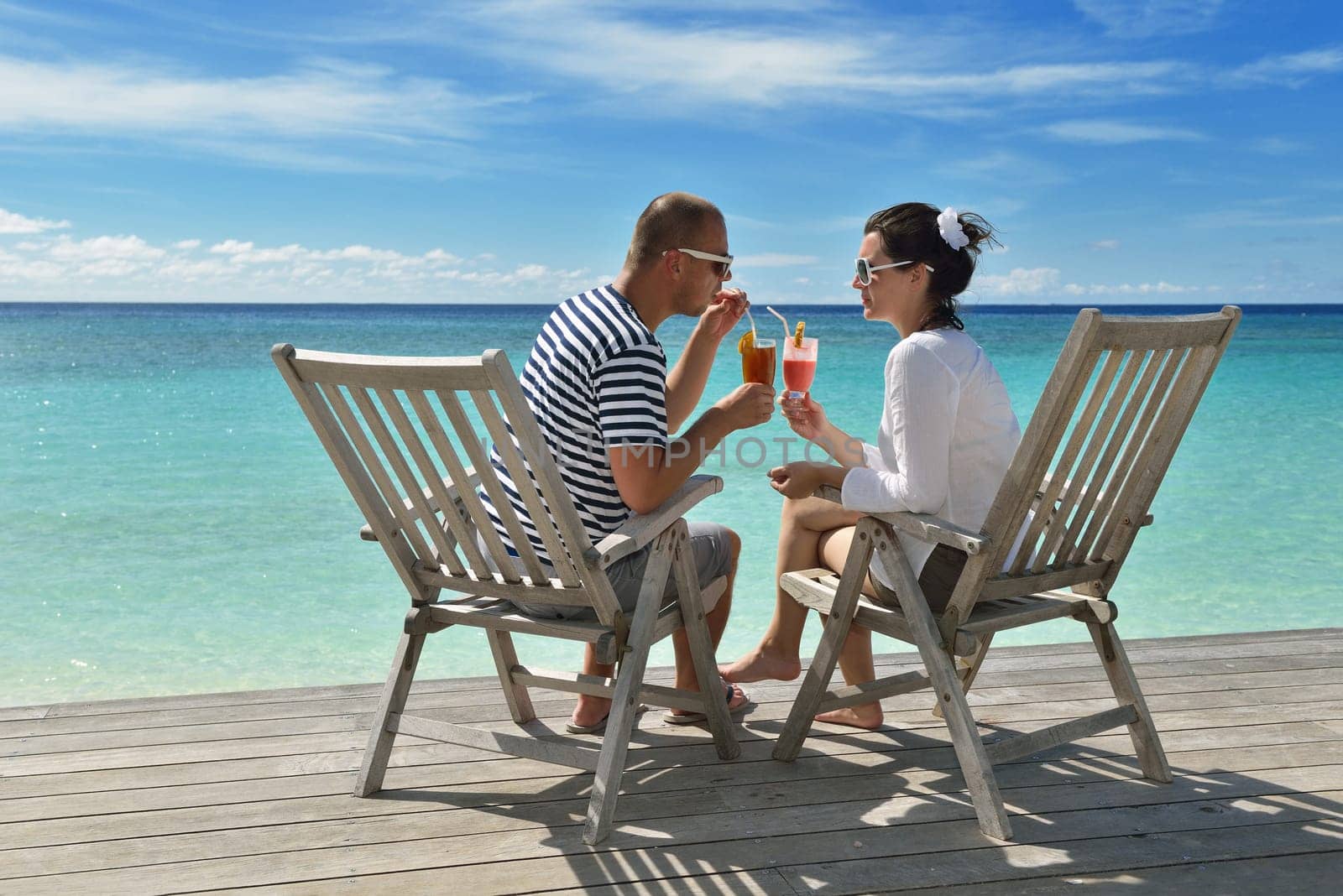 happy young couple relax and take fresh drink at summer vacation