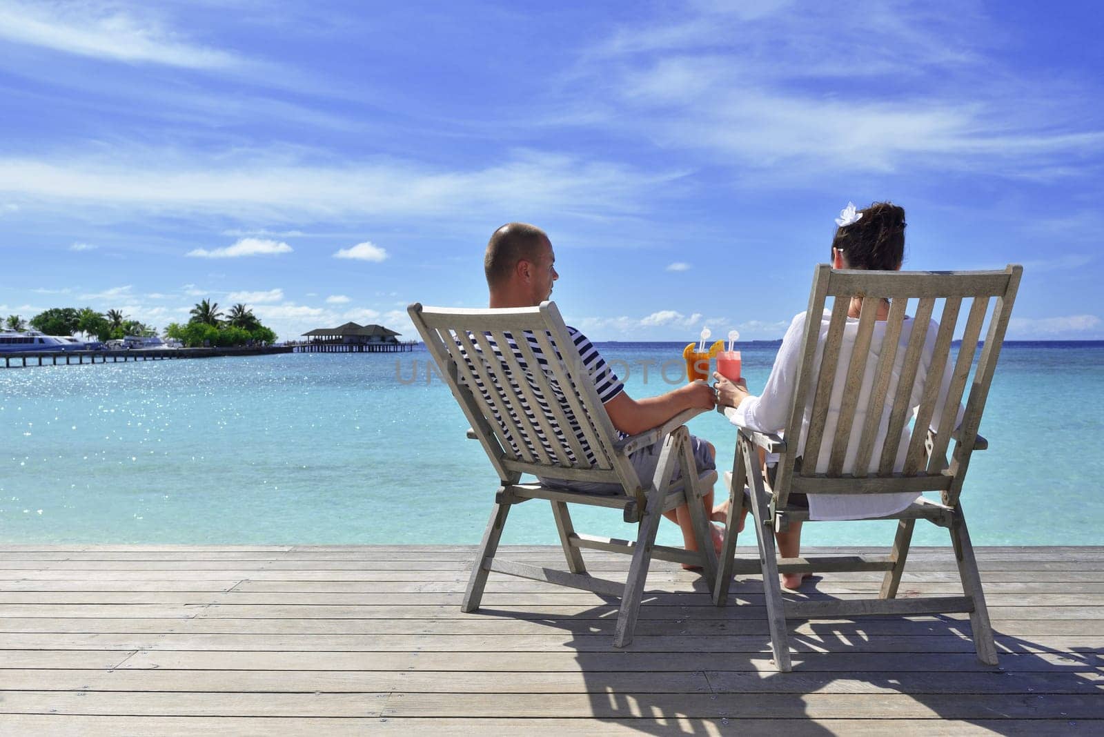 happy young couple relax and take fresh drink at summer vacation