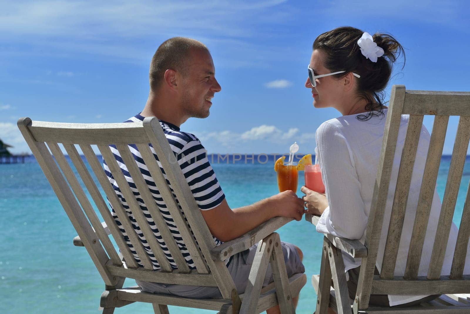 happy young couple relax and take fresh drink at summer vacation