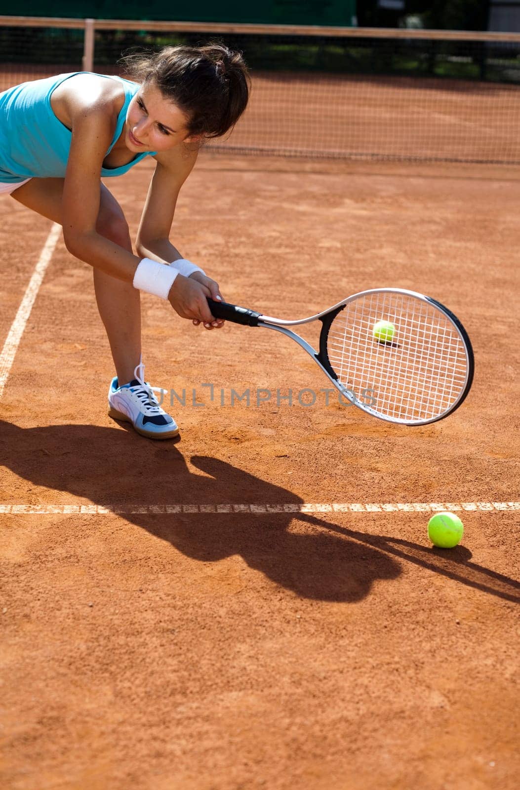 Young woman tennis player on the court