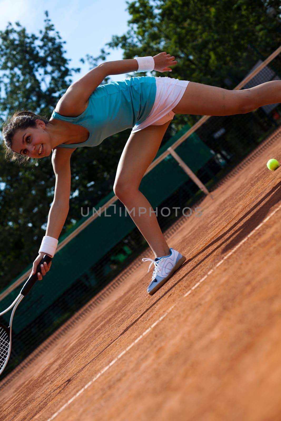 Young woman tennis player on the court