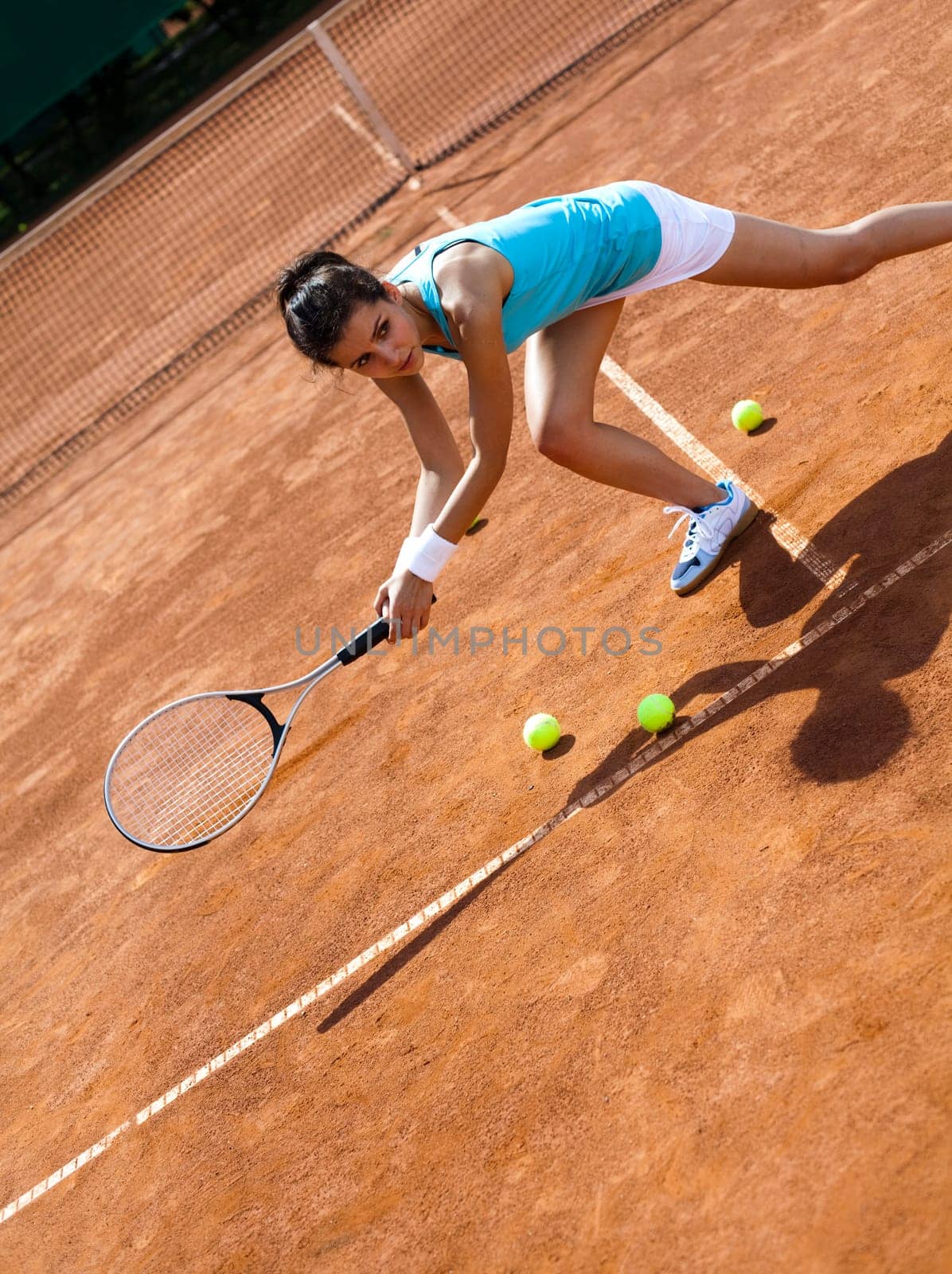 Young woman tennis player on the court
