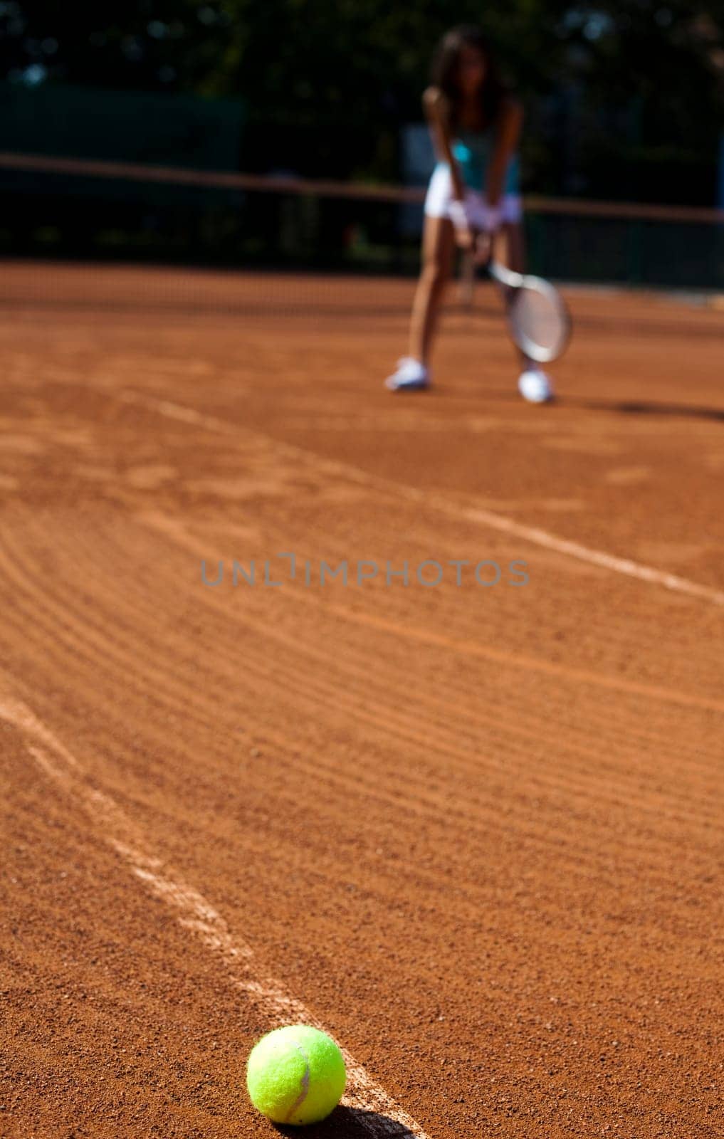 Young woman tennis player on the court