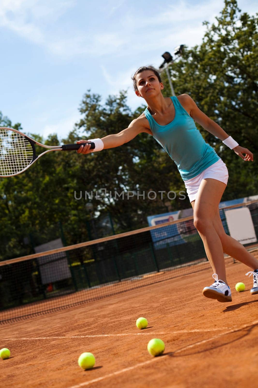 Young woman tennis player on the court
