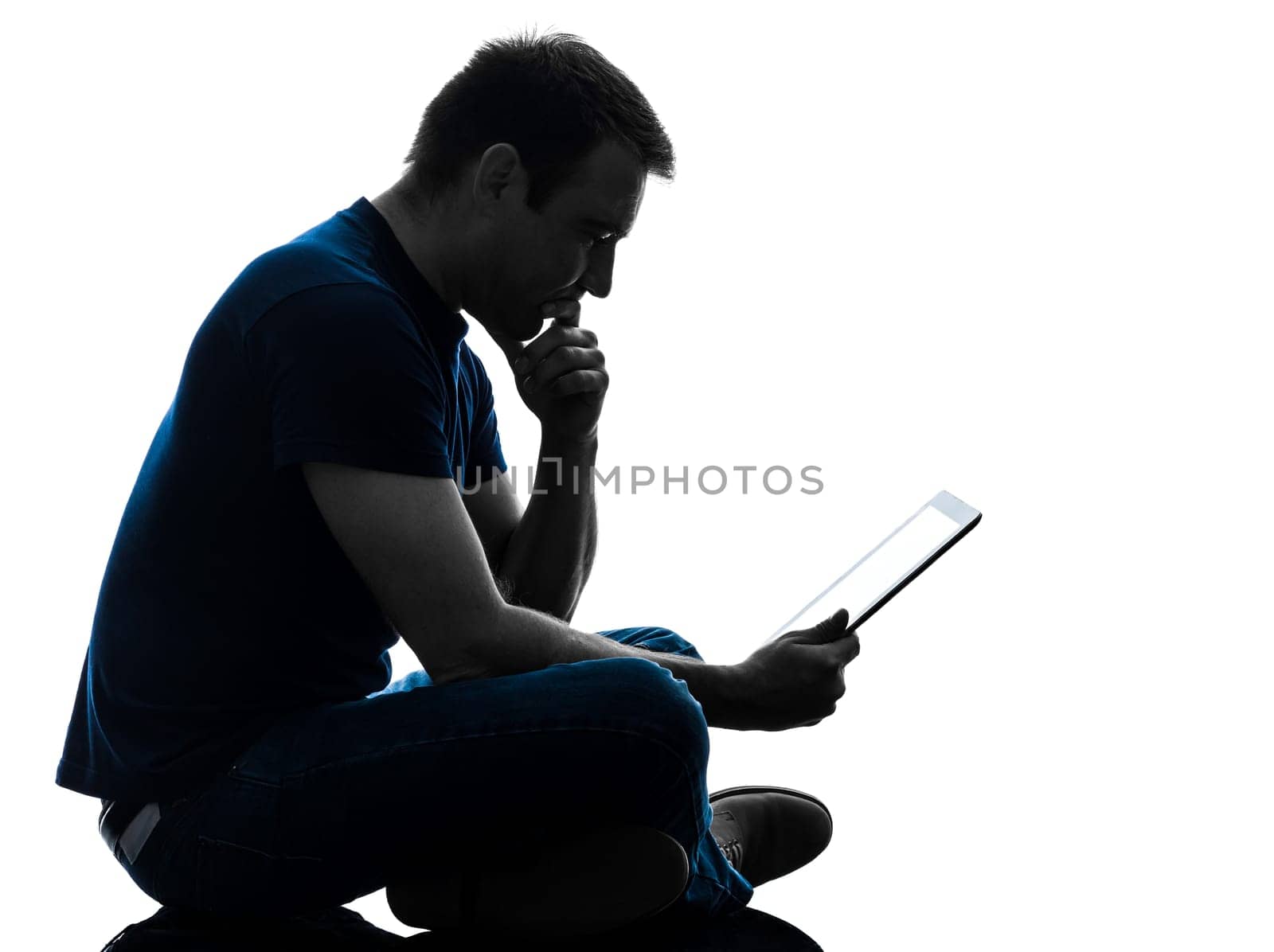 one caucasian man  sitting holding digital tablet   in silhouette on white background