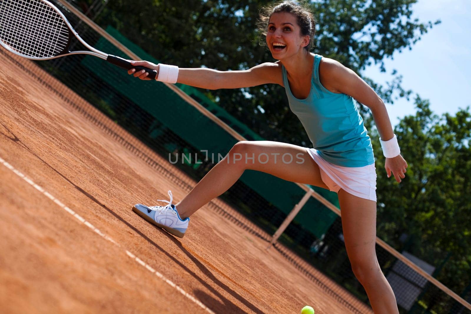 Young woman tennis player on the court