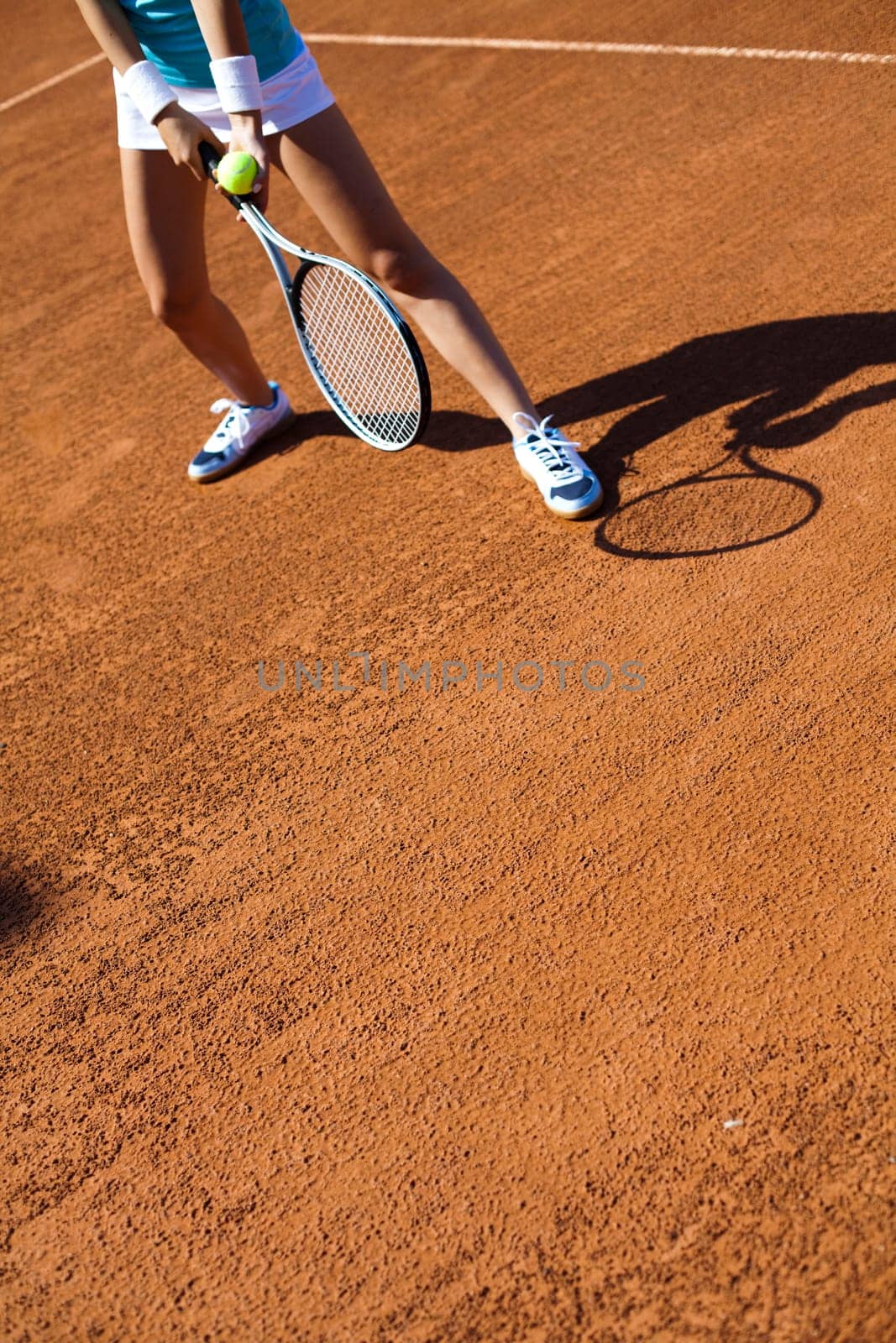 Young woman tennis player on the court
