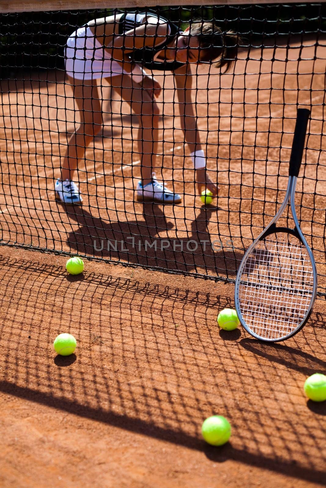 Young woman tennis player on the court